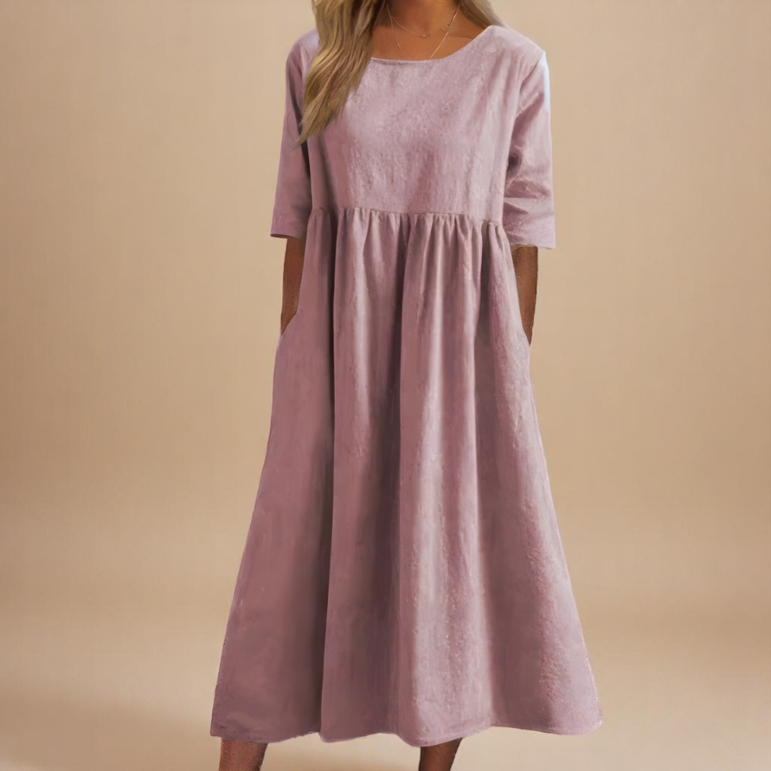 Elegant women's empire waist midi dress with half-sleeves. Its gathered waist creates a flowy silhouette.