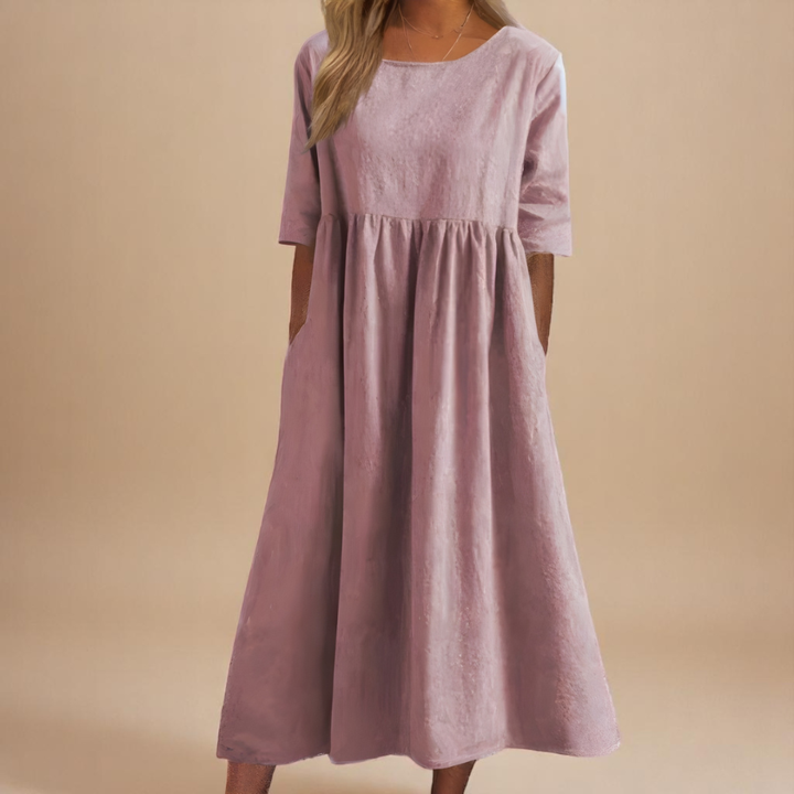Elegant women's empire waist midi dress with half-sleeves. Its gathered waist creates a flowy silhouette.