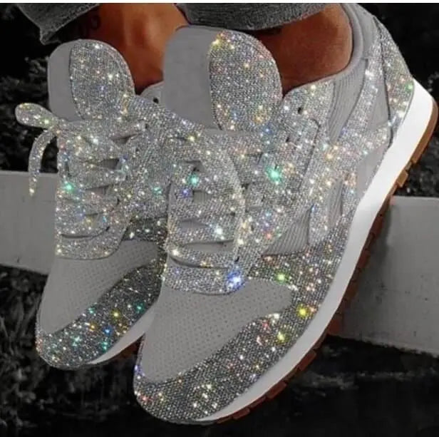 Close-up of women's trendy glitter lace-up sneakers. Shimmering fabric & comfortable design for casual wear.