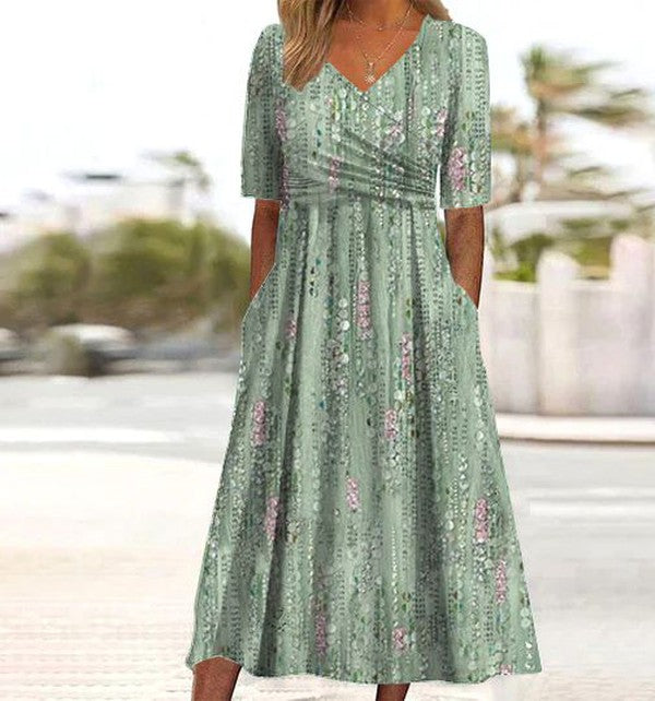 Women's green printed summer midi dress with flared skirt, V-neck, short sleeves. Elegant casual vacation outfit.