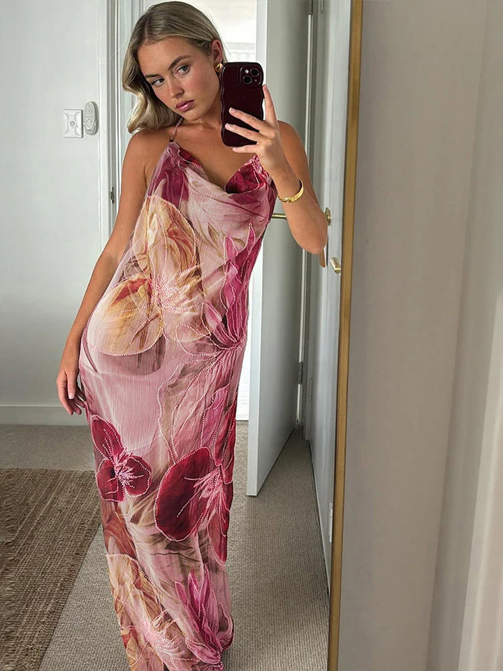 Sleeveless floral print maxi dress with halter neck, ideal for a wedding guest or party.
