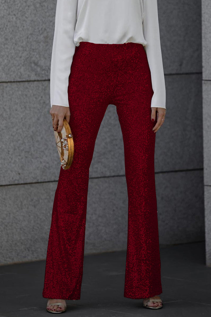 Glamorous women's flared sequin trousers, ideal for a party or evening event, shimmering elegantly.