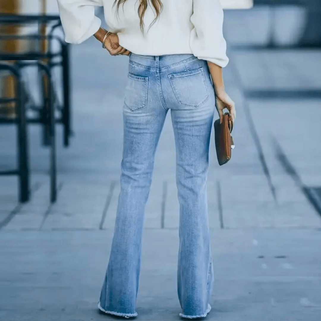 Close-up of women's straight leg high-waist jeans fabric, showing denim texture for casual wear.