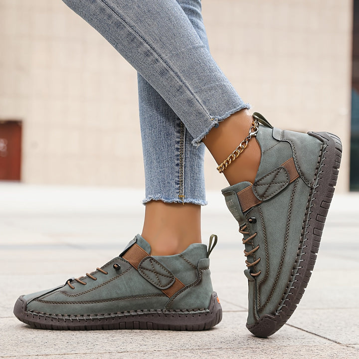 Women's lace-up flat sneakers with decorative stitching, perfect for casual everyday wear & comfort.