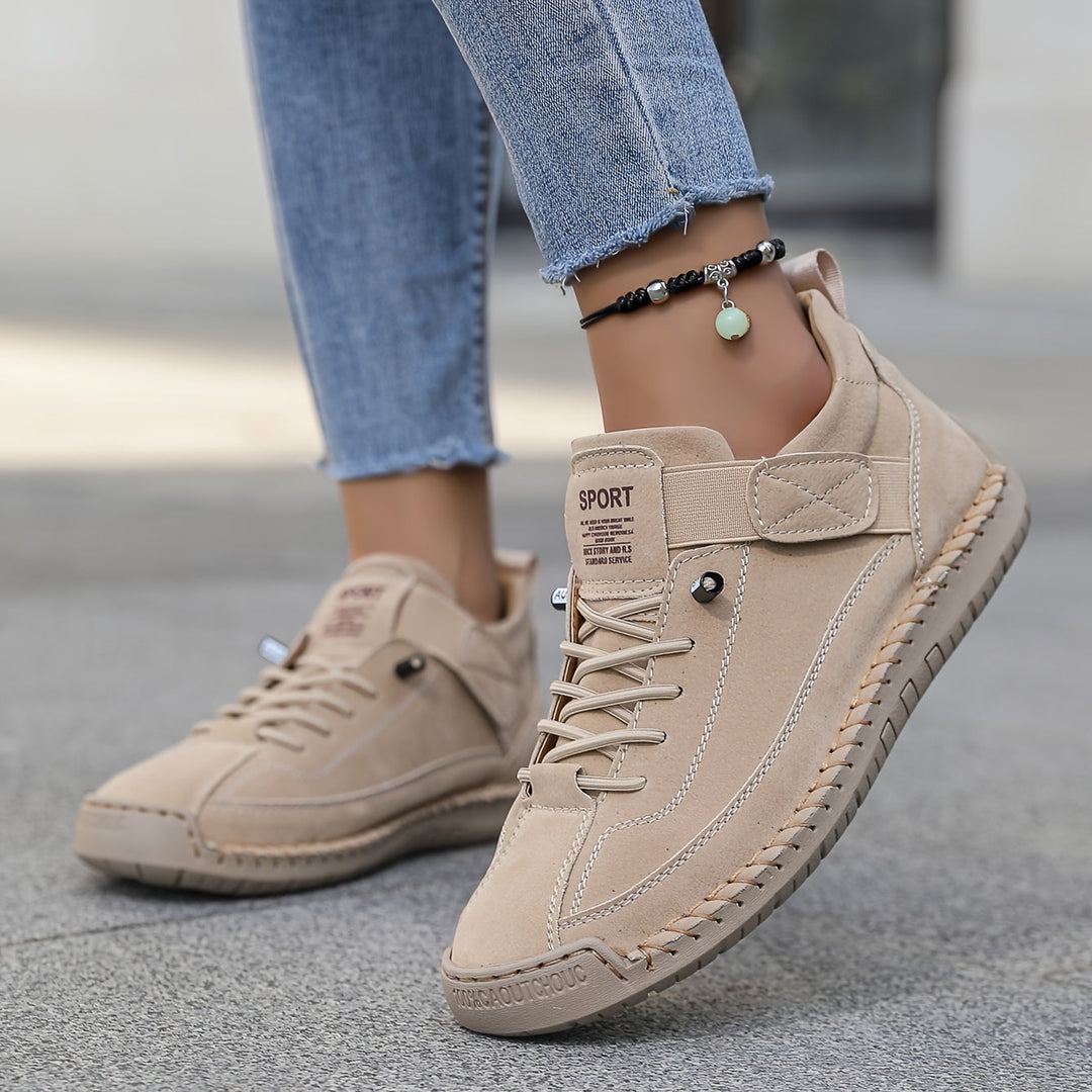 Chic women's fashion sneakers featuring unique decorative stitching & practical lace-up flat design.