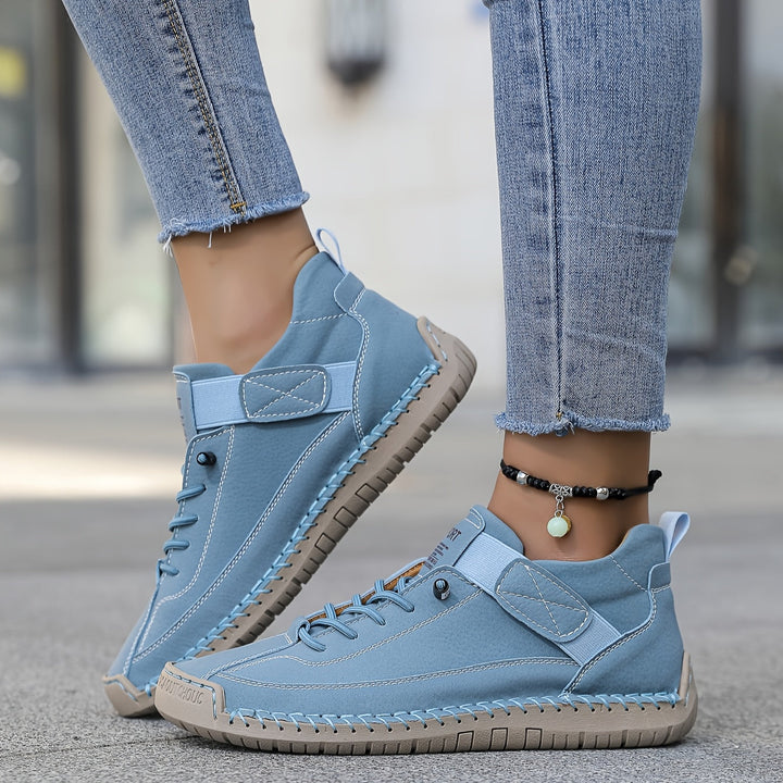 Everyday women's lace-up flat sneakers, comfort casual footwear with eye-catching decorative stitching.
