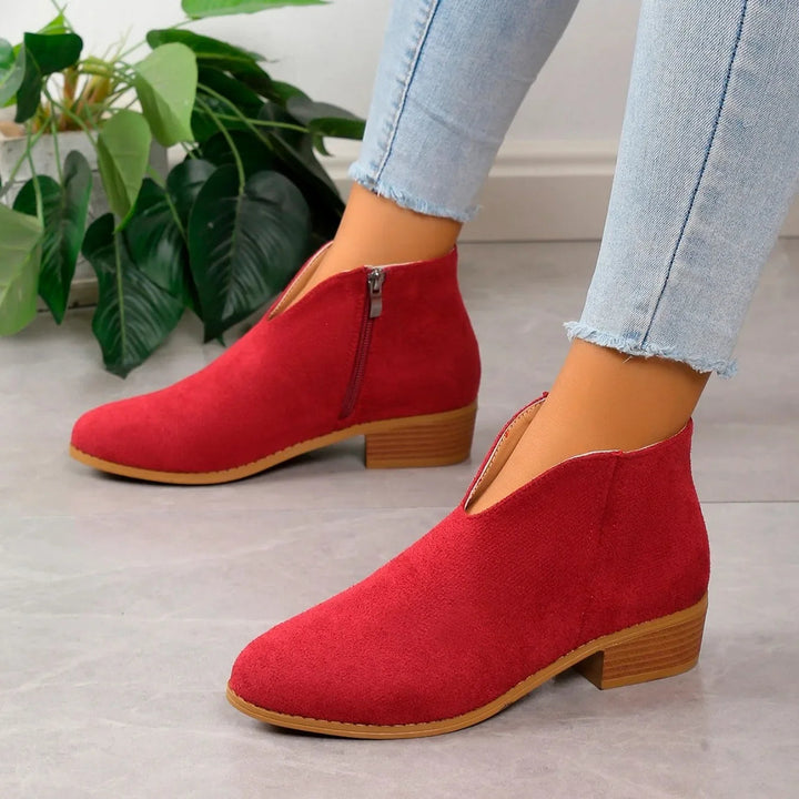 Modern women's ankle boots in a vibrant leopard print, complete with a durable zipper fastening.
