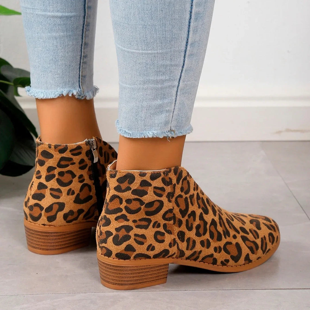 Pair of women's leopard print fashion boots, perfect for fall and winter outfits, with chunky heels.