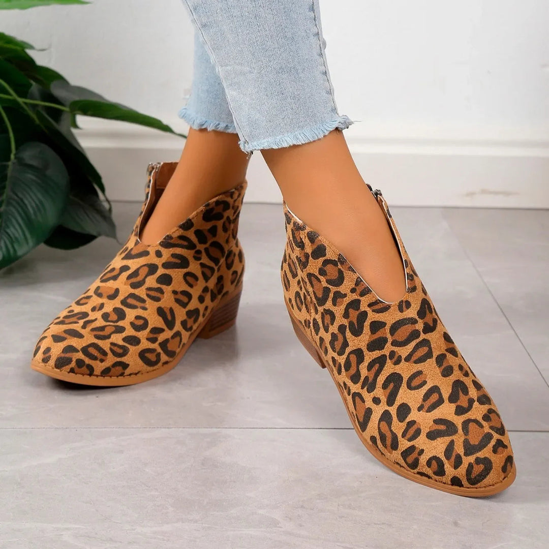Stylish women's ankle boots in a bold leopard print, designed for comfort and fashion with a zipper.