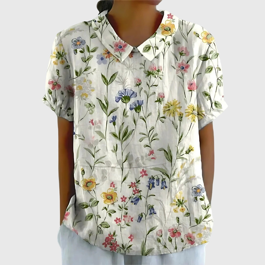 Model wearing a versatile women's floral top, showcasing its relaxed fit & elegant casual style.