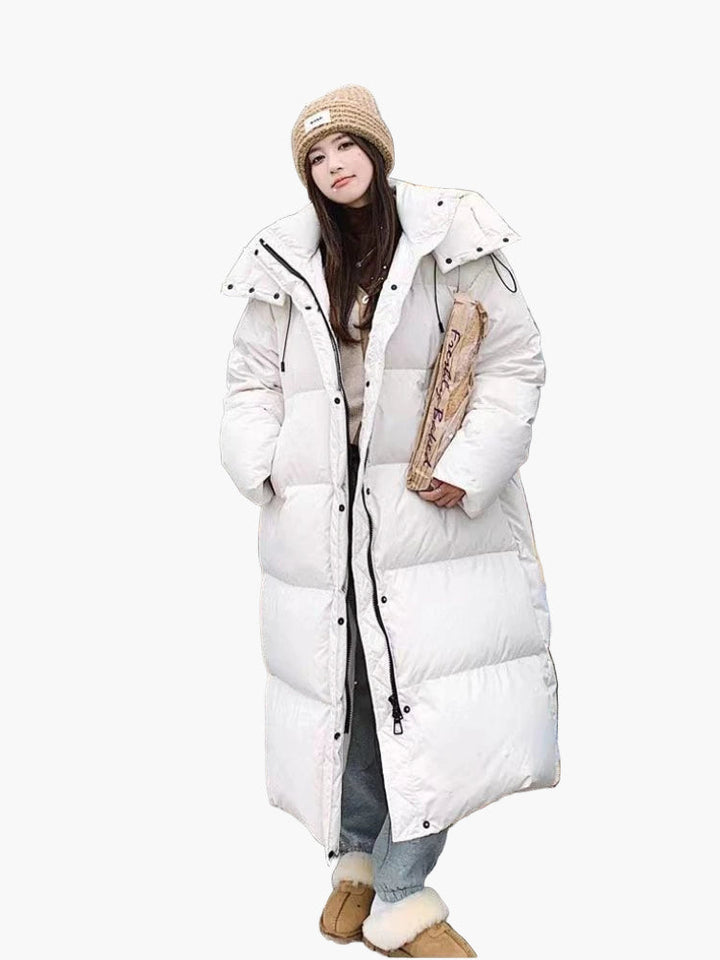 Close-up of the quilted texture and hood on a women's long puffer coat, perfect for winter