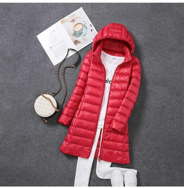 Stylish women's long puffer jacket, perfect fall & winter outerwear. Features a practical detachable hood.