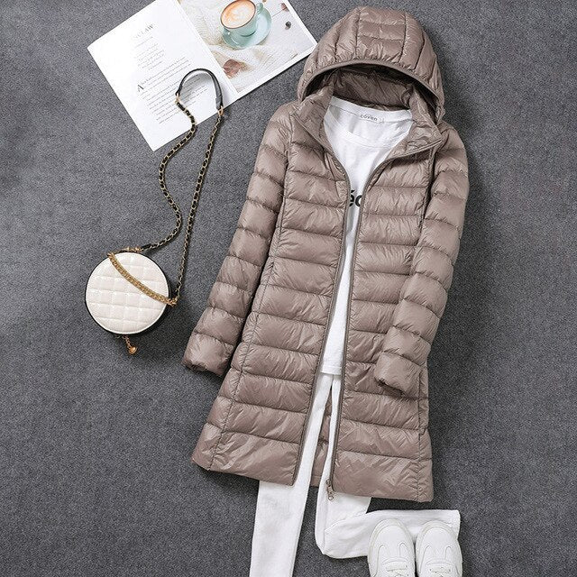 Women's long puffer winter jacket, featuring a detachable hood. This warm outerwear is perfect for fall & winter.