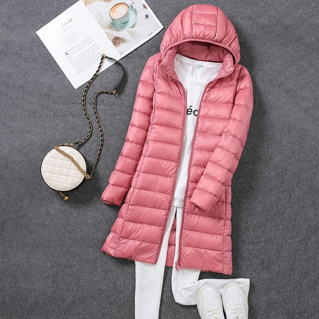 Fashionable women's long puffer coat with a detachable hood, excellent for cold weather & winter style.