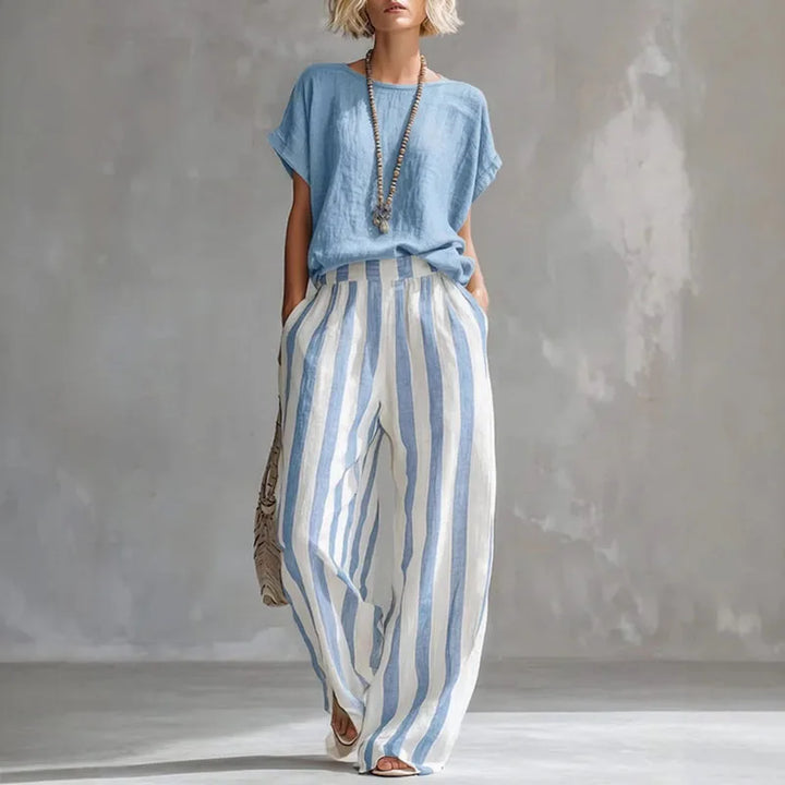 Close-up of breathable striped cotton-linen fabric on a women's loose summer two-piece outfit.
