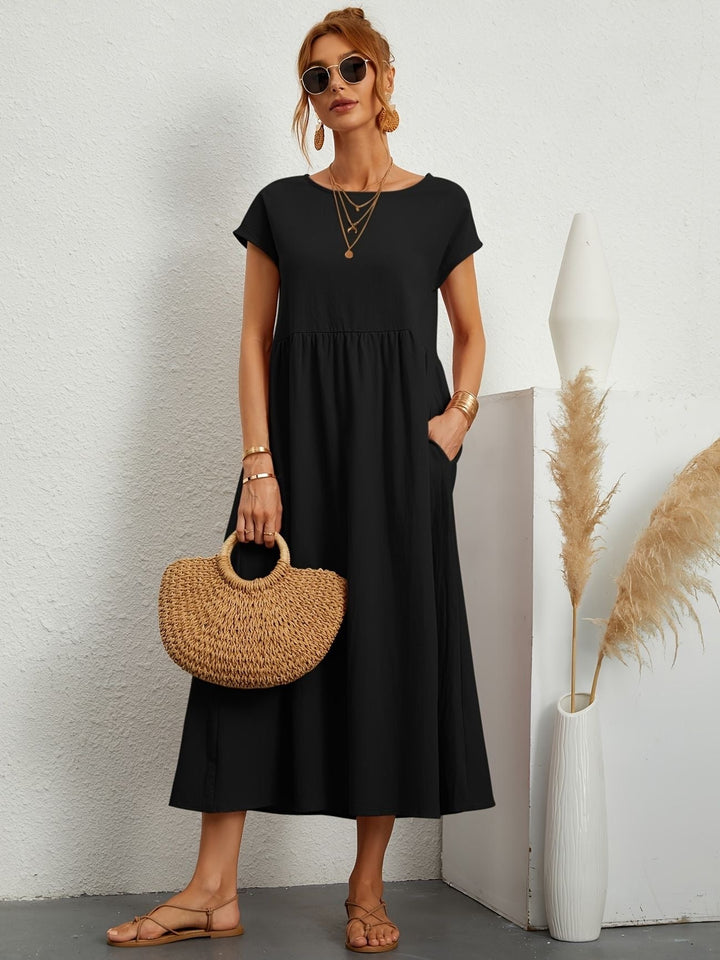 Flowy women's loose fit short sleeve maxi dress, round neck, with practical side pockets for comfort.