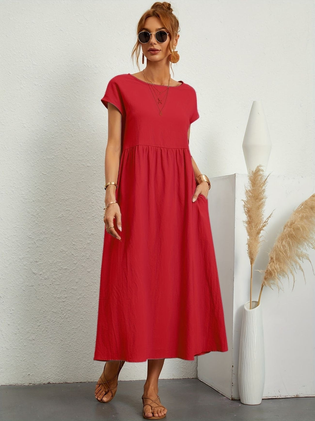 Round neck women's maxi dress with short sleeves & side pockets, offering a comfortable loose fit.