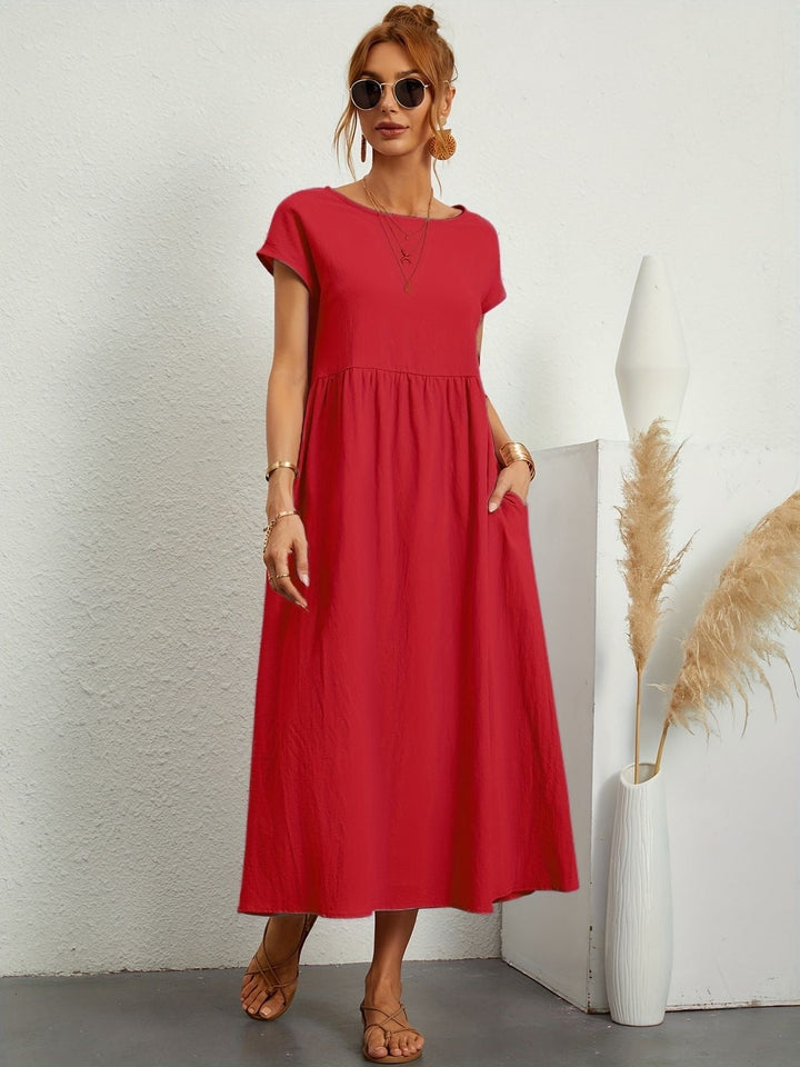 Round neck women's maxi dress with short sleeves & side pockets, offering a comfortable loose fit.