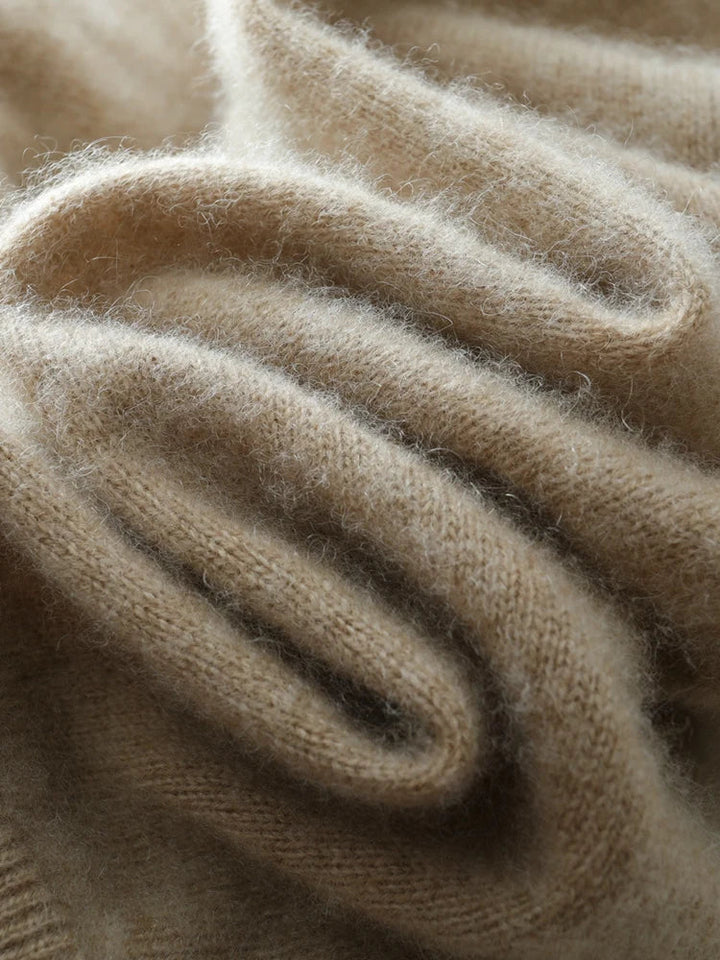 A model smiling while wearing the comfortable Women's Luxe Cashmere Knit Crossover Sweater, soft wear