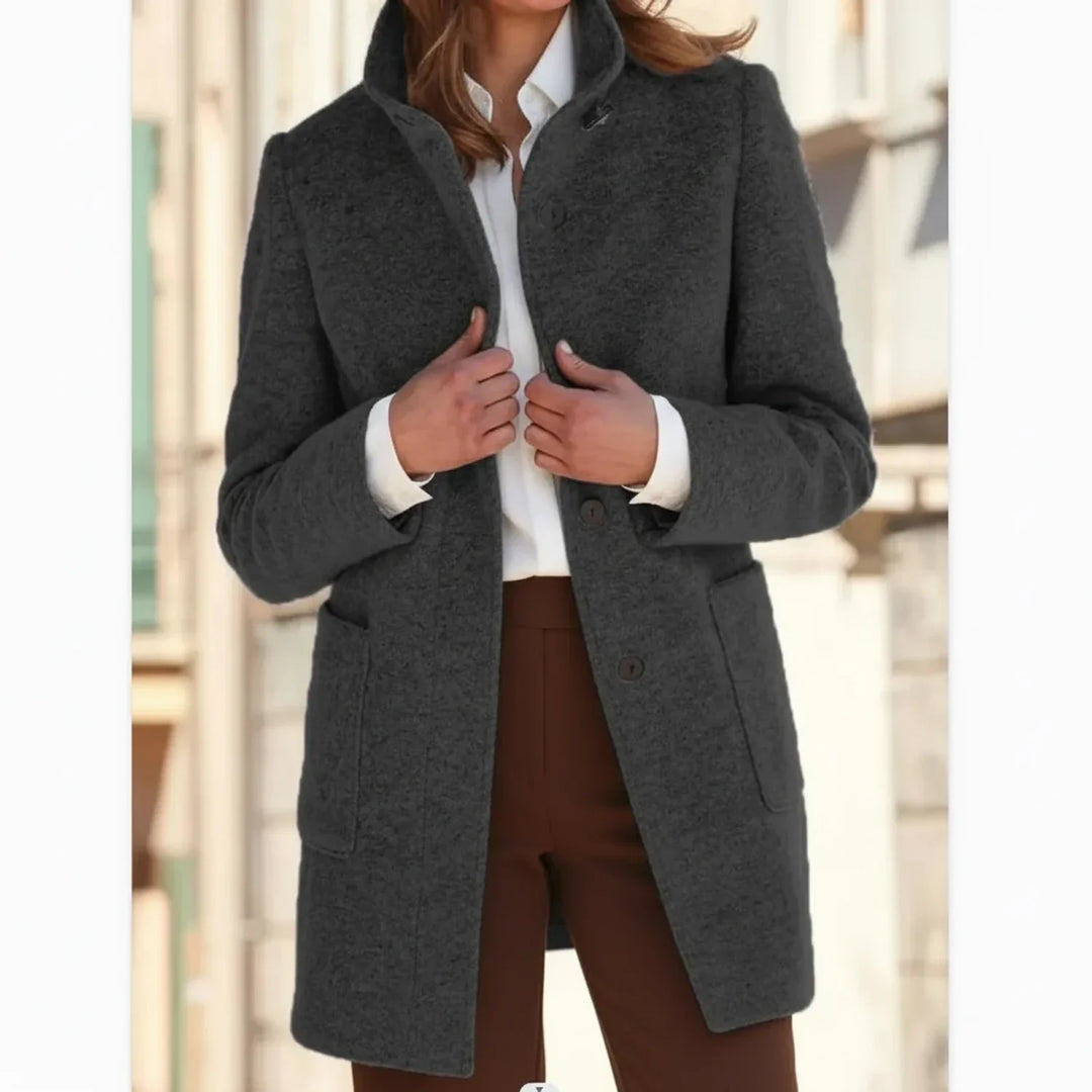 Warm women's mid-length winter coat, stylish outerwear for cold fall days. Features cozy fabric & relaxed fit.
