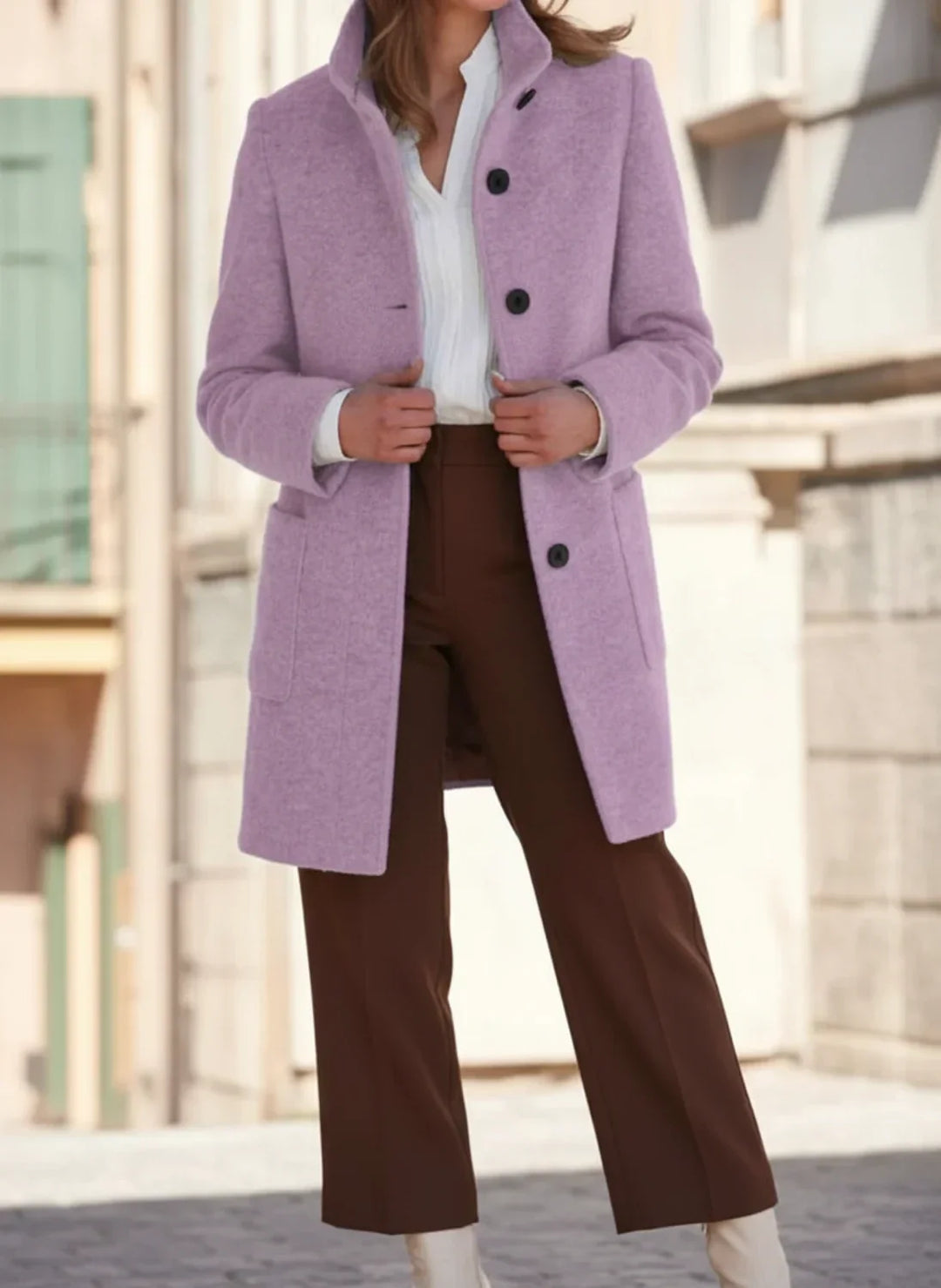 Front view of a women's mid-length fall winter coat, showing its classic style & warm, button-front design.