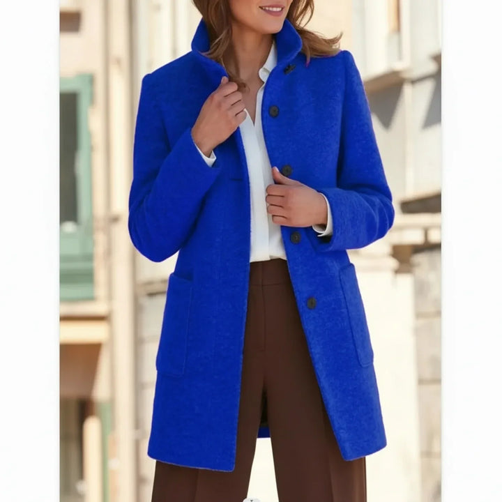 Detailed shot of a women's mid-length winter coat, highlighting its stylish design and quality warm fabric for fall.