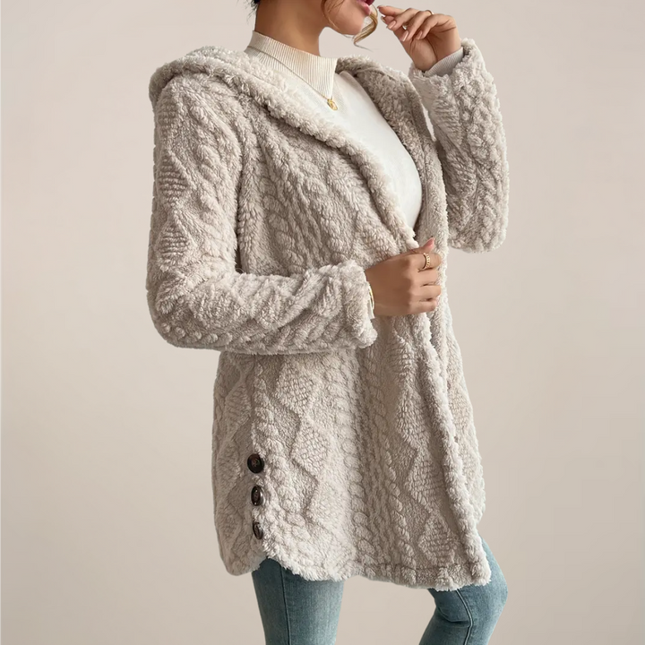 Close-up of the soft textured knit on a women's hooded cardigan, ideal for spring fashion