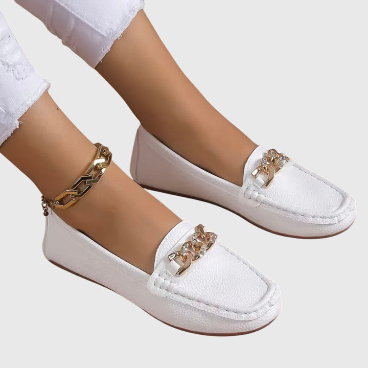 Women's orthopedic loafers showing supportive sole & comfortable heel. Chic, versatile slip-on footwear.