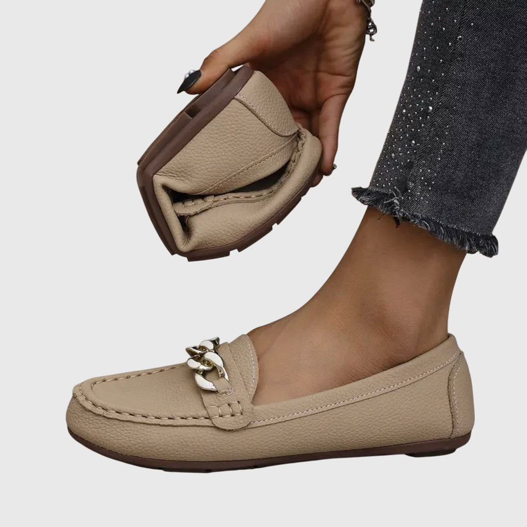 Women's fashion loafers featuring an elegant gold chain. Comfortable, orthopedic slip-on design for modern style.