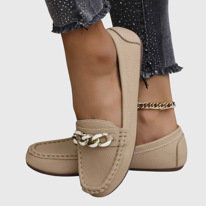 Pair of women's orthopedic loafers worn, showcasing all-day comfort & chic slip-on design.