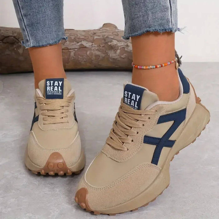 Lace-up women's orthopedic sneakers with modern panel design, ideal for athletic casual and supportive walking.