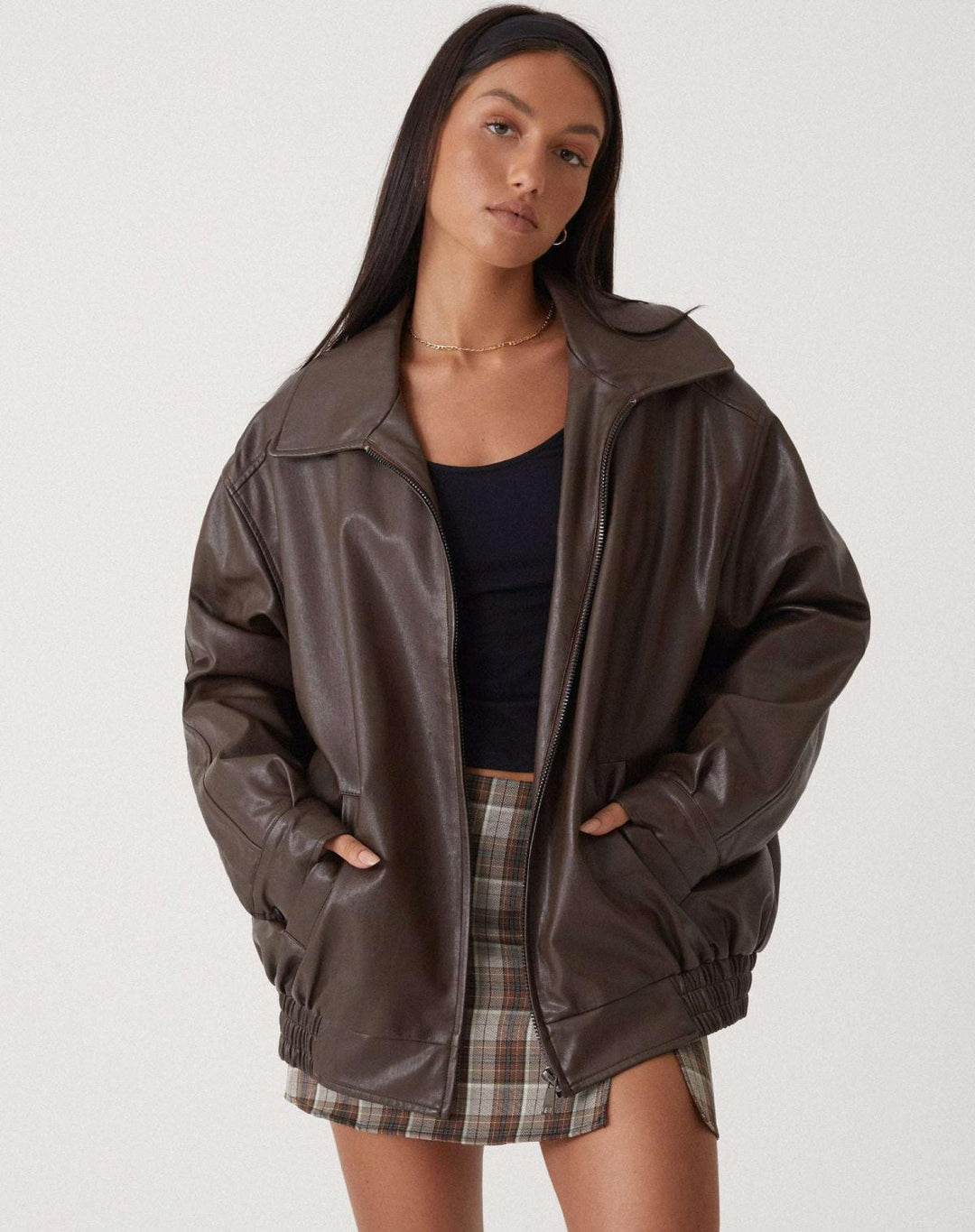 Women's oversized faux leather bomber jacket in rich brown with a relaxed fit, perfect for casual wear.