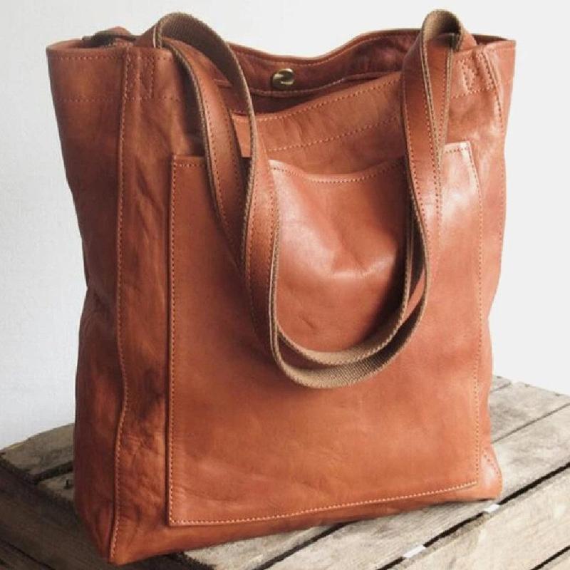 Versatile women's leather work bag or travel tote, with ample space & practical external pocket.