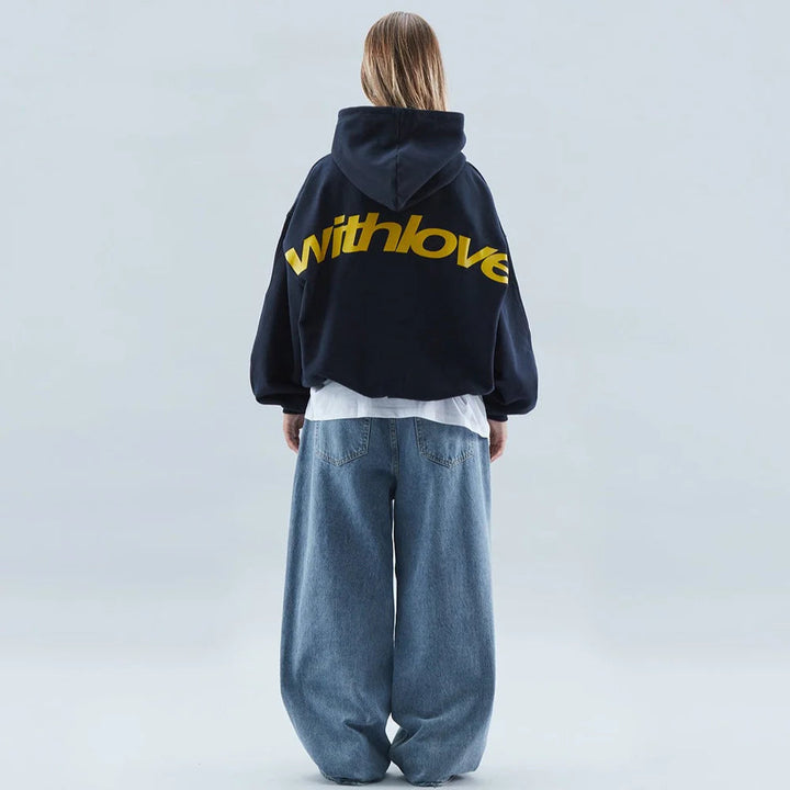 Stylish women's cropped hoodie with bold graphic, oversized fit, drop shoulders, and long sleeves.