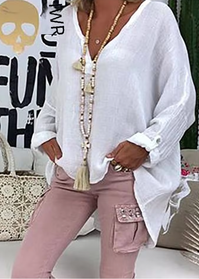 Modern women's oversized long sleeve button-up blouse. Effortless style, versatile fashion for any occasion.