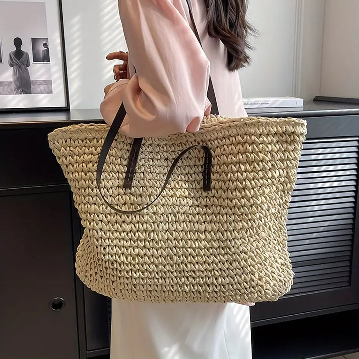Durable woven straw travel bag for women, an oversized tote perfect for summer vacations.