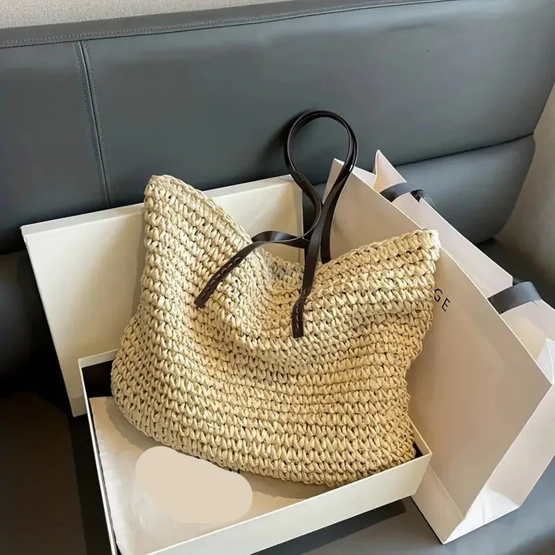 Lightweight women's oversized straw beach tote bag, ample storage for summer outings.