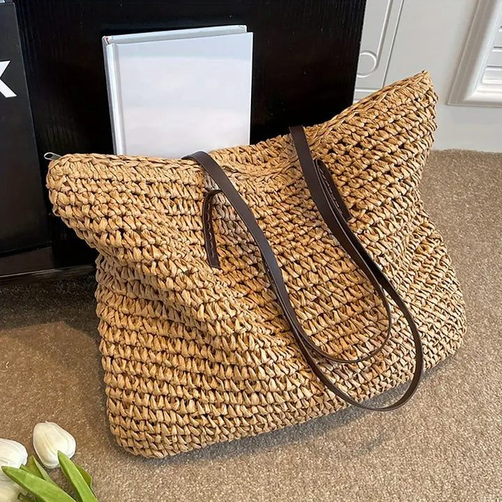 Trendy women's oversized straw tote bag, ideal for beach holidays and summer fashion statements.