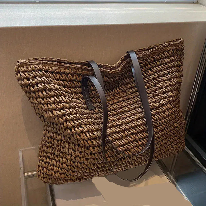 Handwoven straw tote bag for women, an oversized beach essential for chic summer style.