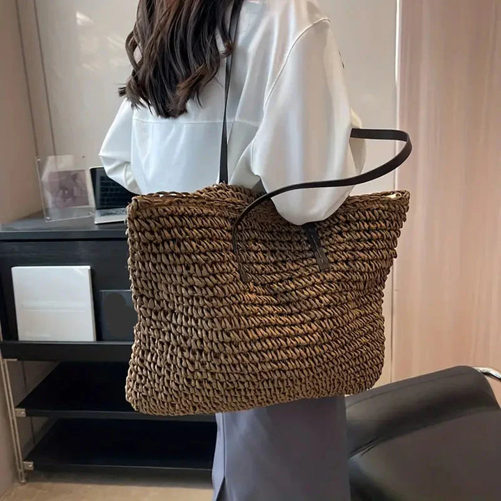 Spacious women's straw tote bag, perfect as a beach, travel, or casual summer handbag.