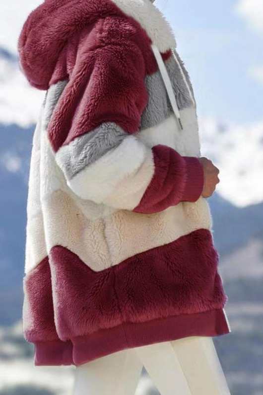 Plush women's oversized teddy coat with a fashionable striped hood, perfect for cozy winter fashion.