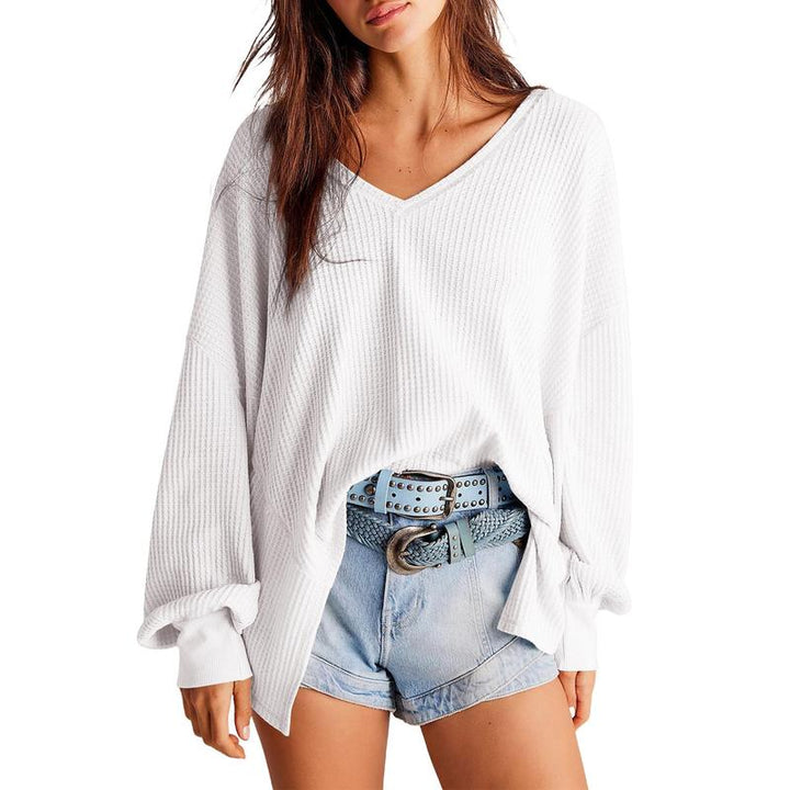 Close-up of a women's comfortable knit V-neck sweater, showing the waffle texture and soft fabric