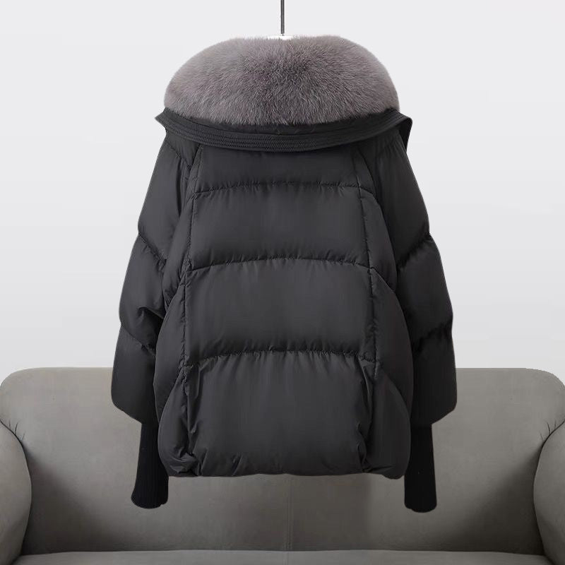 Front view of a women's padded winter jacket with a prominent fur collar, perfect for cold climates