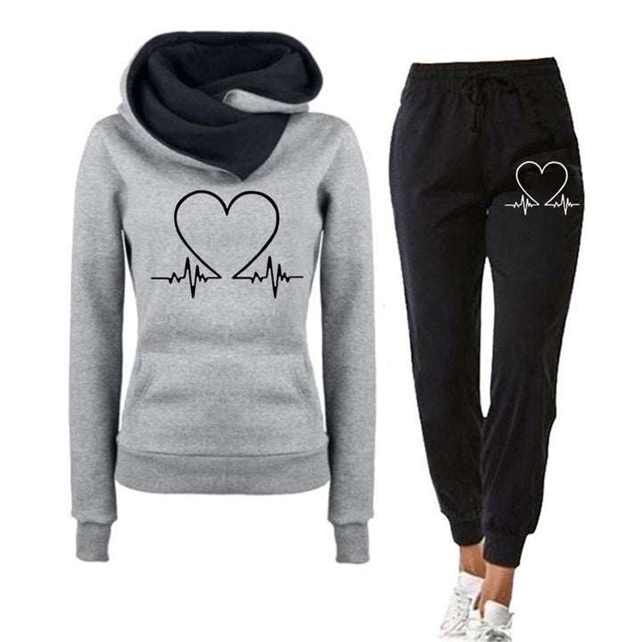Relaxed fit women's loungewear set in pink with a cute heart graphic on hoodie and pants