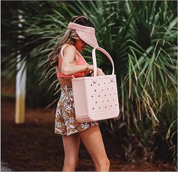 Women's pink washable EVA beach tote bag with vent holes; perfect for sandproof summer travel.