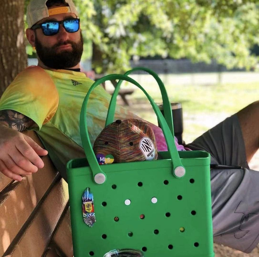 Black women's waterproof EVA tote, large and vented, ideal for beach days or summer travel.
