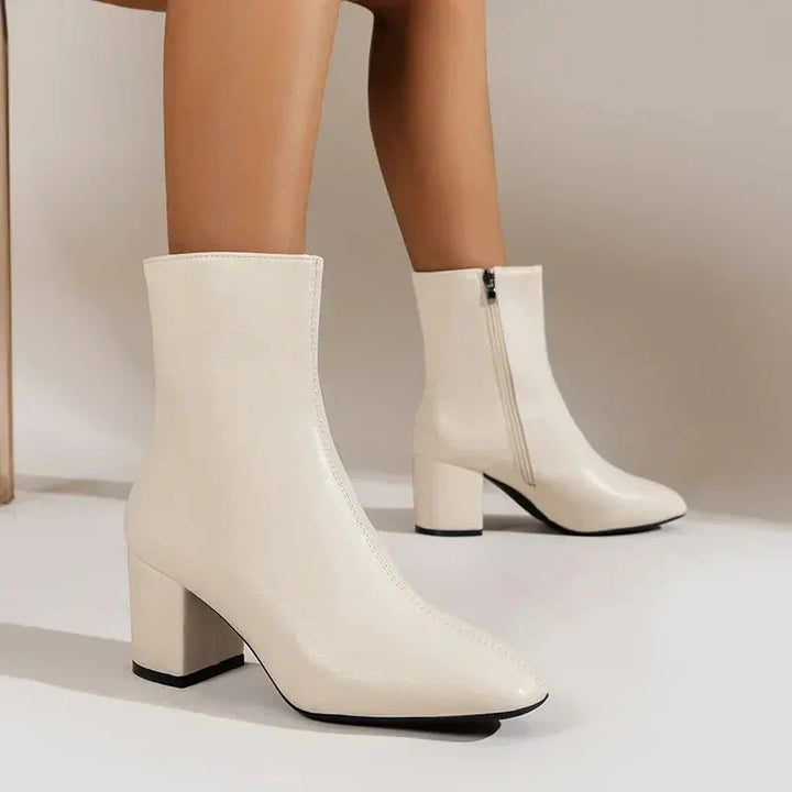 Stylish women's leather ankle boots featuring a sleek design, block heel, and almond toe, ideal for diverse outfits.