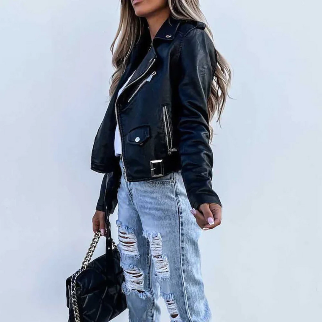 Close-up of the textured faux leather and silver zip detail on a versatile women's biker jacket.