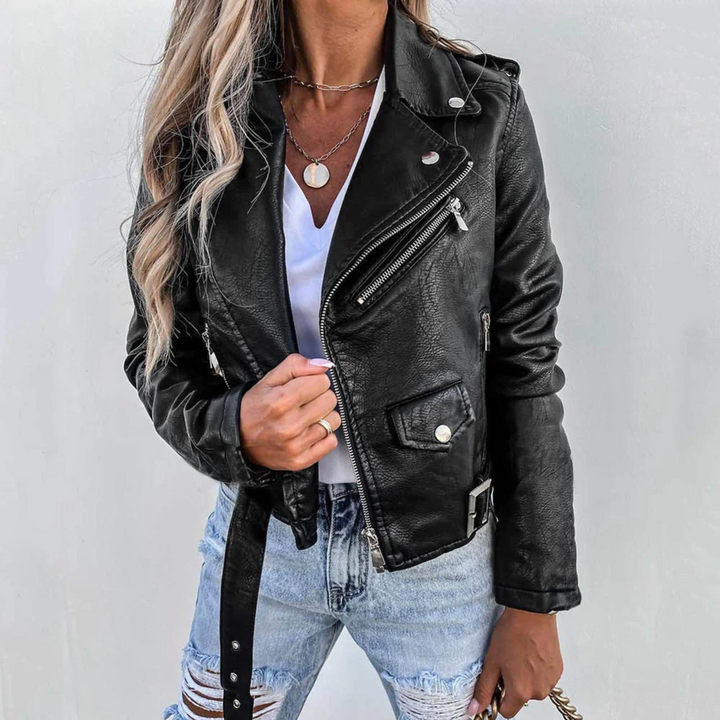 Full shot of a women's trendy red faux leather zip-up biker jacket, showcasing its fashionable design.
