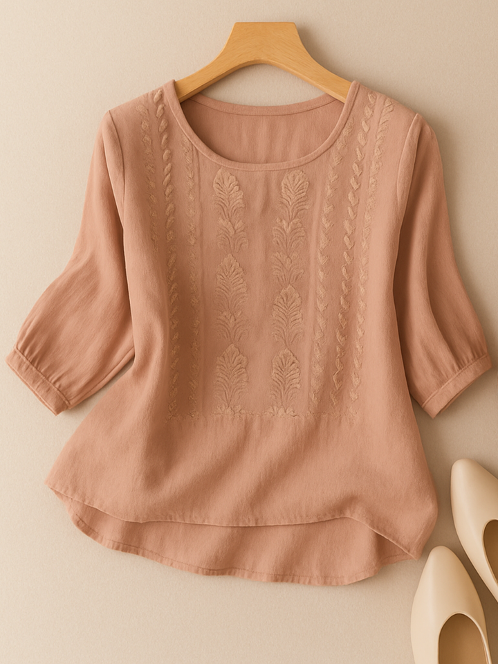 Casual women's blouse featuring intricate embroidery, relaxed fit, and stylish three-quarter sleeves. Effortless elegance.